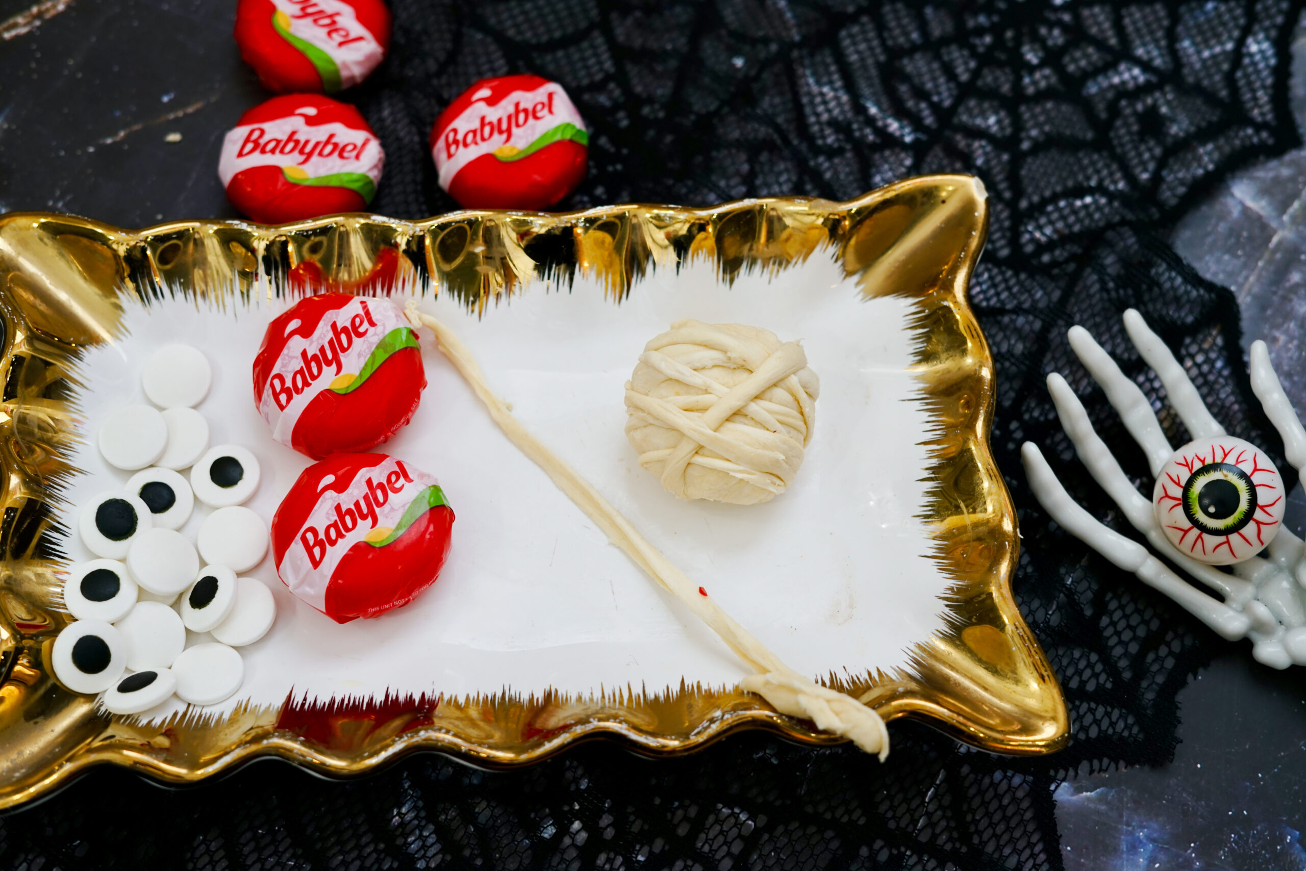 wrapping babybel cheese with crescent rolls